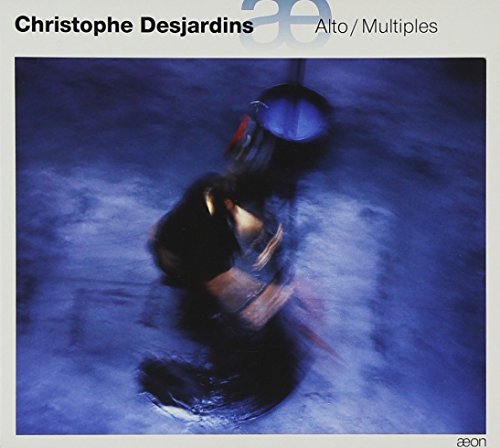 A CD cover featuring a blurry, dark figure against a blue background.