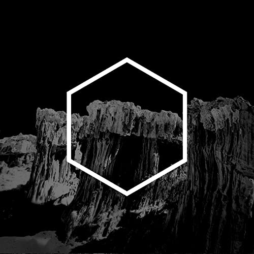 Black and white album cover with a hexagonal frame and rocky landscape.