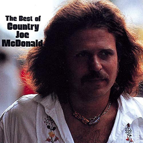 Close-up portrait of Country Joe McDonald with long, wavy hair and a mustache.