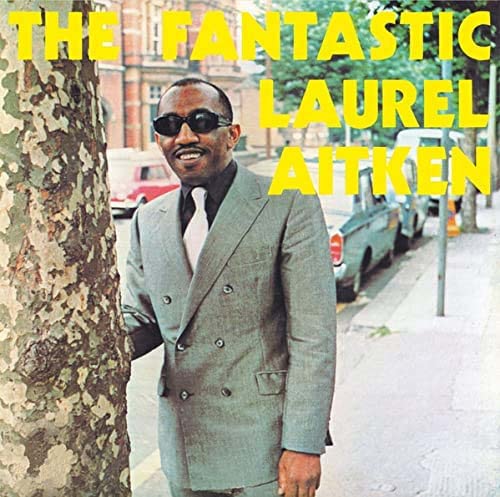 Laurel Aitken album cover: man in suit, tree, cars in background.