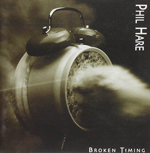 "Album cover with broken alarm clock exploding, smoke and debris, artist and title displayed."
