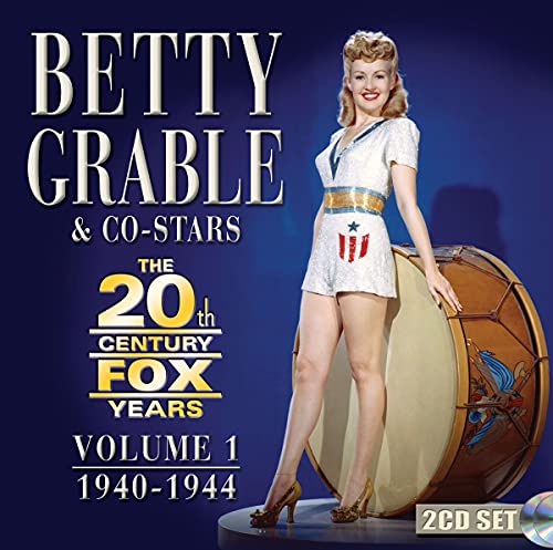 Betty Grable standing beside a large drum on a blue background, CD cover art.