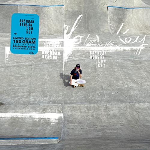 Album cover for "Low Key" by Brendan Benson, featuring a person on concrete.