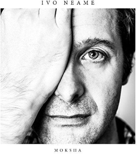 Black and white album cover featuring a man's face partially obscured by a hand.