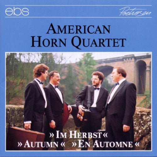 "CD cover with four men in tuxedos standing outdoors, blue background, text 'American Horn Quartet'."