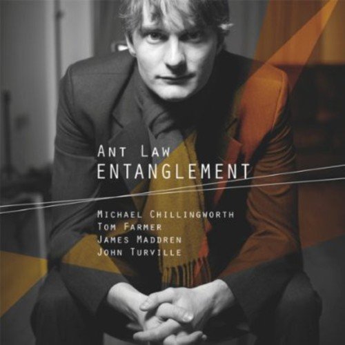 Album cover with man in suit and names listed, geometric shapes overlay.