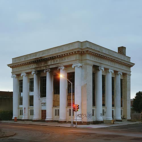 Classical building with columns, titled "The Price of Progress" album cover.