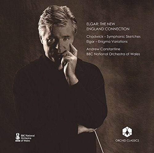 "CD cover with a man in black, hand on chin, against a dark background."