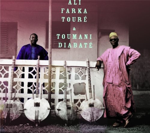 "Album cover with two men in traditional robes standing beside a white metal fence."