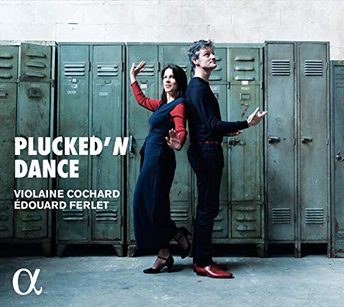 A man and woman dance in front of green metal lockers, album cover artwork.