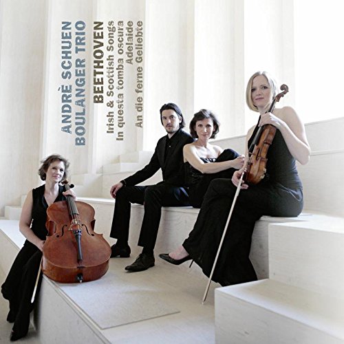 "CD cover featuring three musicians posing with their instruments in a white room."