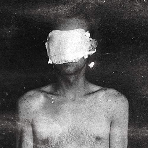 Black and white portrait of a person with a bandaged face.