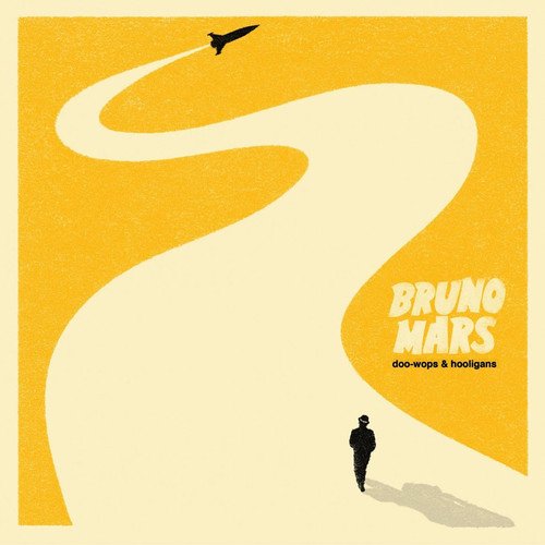 Bruno Mars album cover: yellow background, winding road, man walking, and a flying plane.