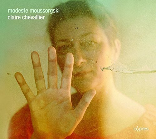 A CD cover featuring a woman's face and hand on a foggy glass.