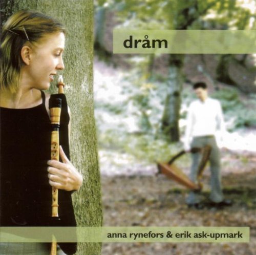 "CD cover featuring a woman playing a flute and a man in a forest."