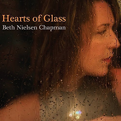 "Album cover with a woman's face behind a rainy window, titled 'Hearts of Glass'."