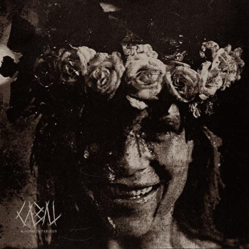 Dark, textured portrait of a face obscured by a floral wreath.