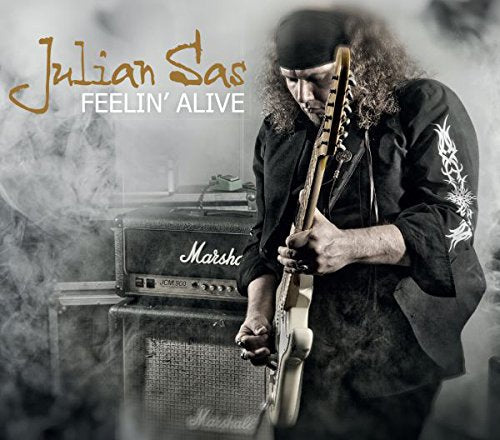Man playing guitar in front of Marshall amplifiers, surrounded by smoke, on album cover.