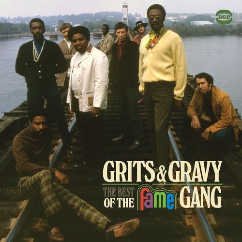 "Album cover featuring a group of men on railroad tracks by a river."