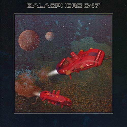 The image depicts a CD cover featuring two red spaceships flying through space. A concise alt text for this image could be: "CD cover with red spaceships and planets in space."