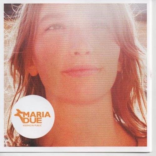 "CD cover with a close-up of a woman's face and orange logo."
