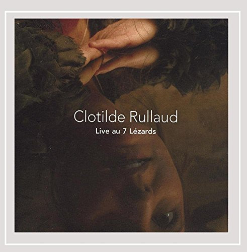 CD cover: close-up of a woman’s face and a hand with feathers.