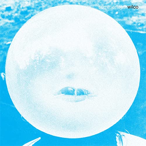 Blue album cover with a blurred face resembling a full moon.