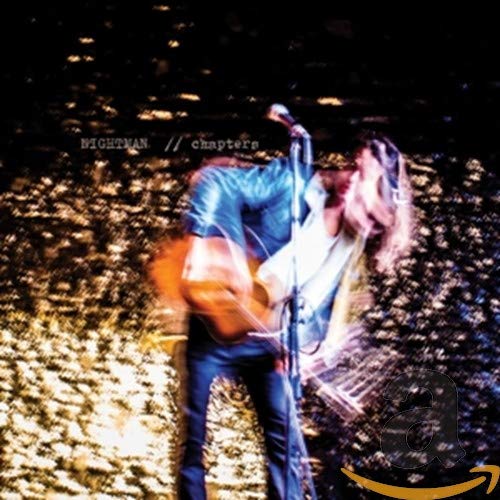 CD cover: blurred image of a musician playing guitar onstage.