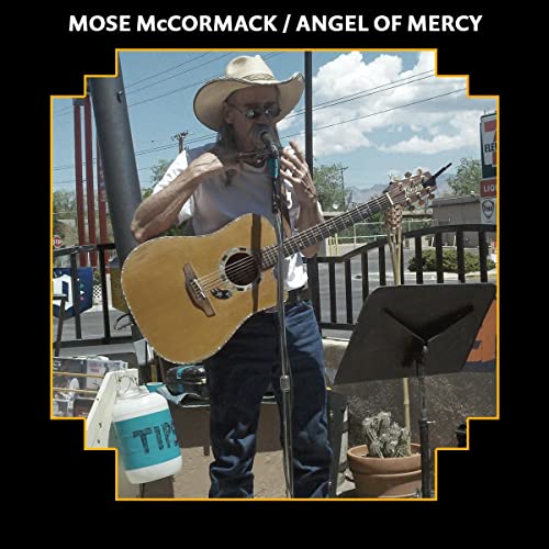Man with guitar and harmonica performing outdoors, CD cover art.