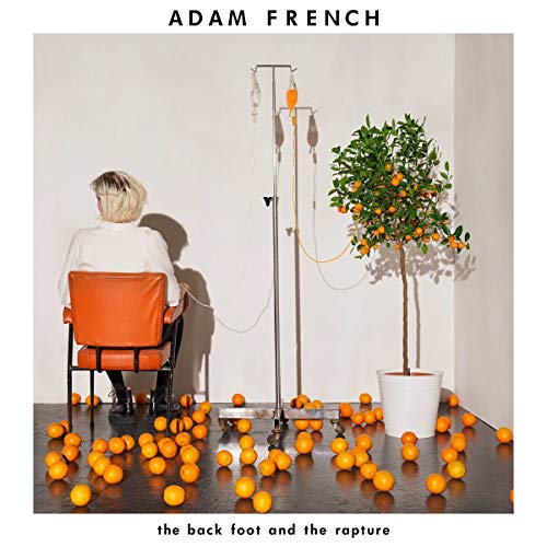 Album cover: person, chair, oranges, and an IV drip in a corner.
