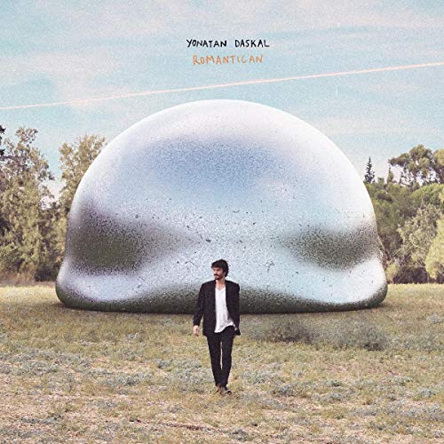 Album cover: man standing before a large, metallic dome in a field.