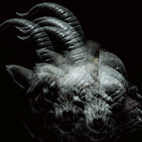 Dark, textured image of a horned, furry creature with multiple faces.