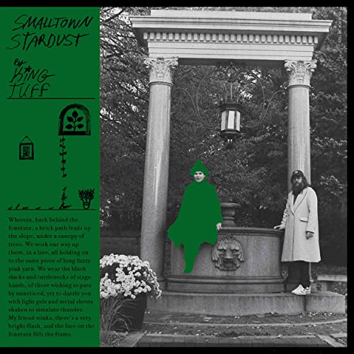 Green album cover featuring a neoclassical fountain and figures in cloaks.