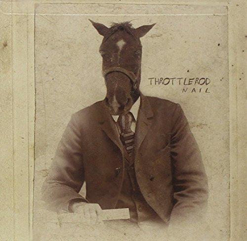 Sepia-toned photo of a person with a horse head wearing a suit.