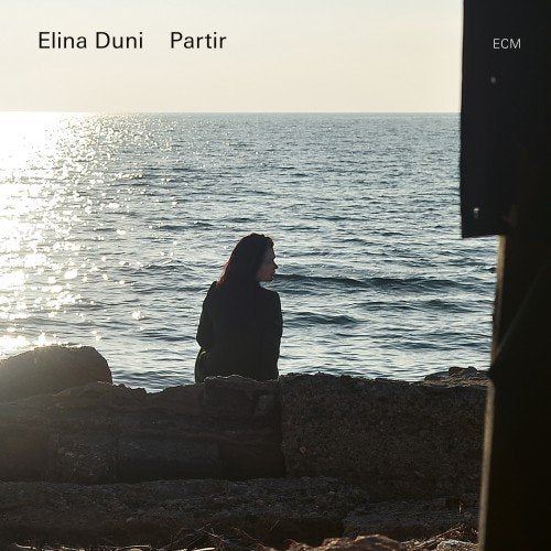 The album cover features a woman standing on rocks by the ocean.