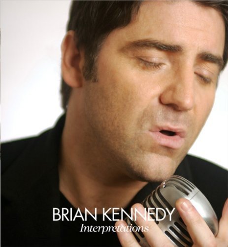 Man with eyes closed, holding a silver microphone, against a white background.