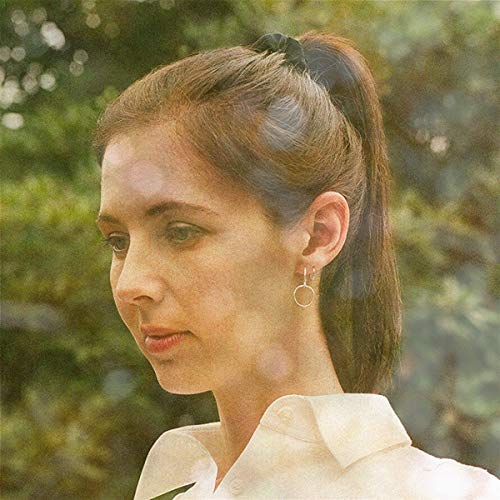 Close-up portrait of a woman with brown hair, looking left.