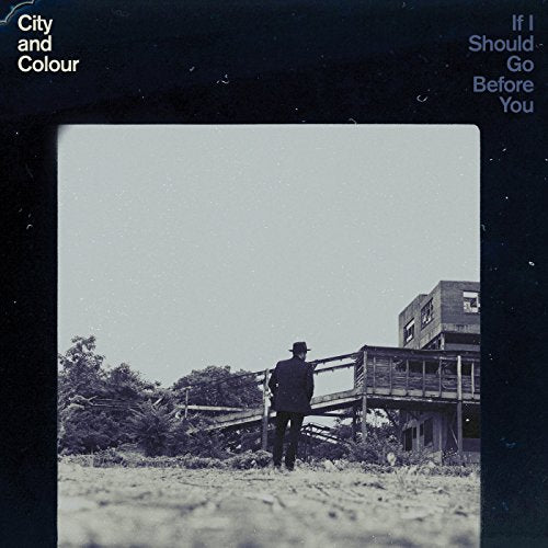 Black-and-white album cover with a man standing by a wooden structure.