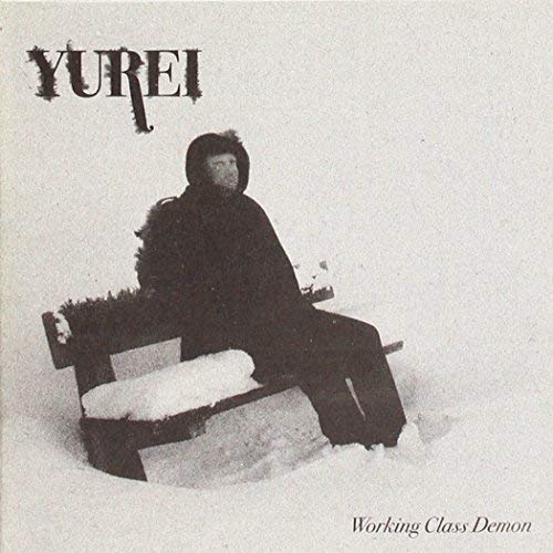 CD cover: grayscale image of person in winter clothing on a bench.