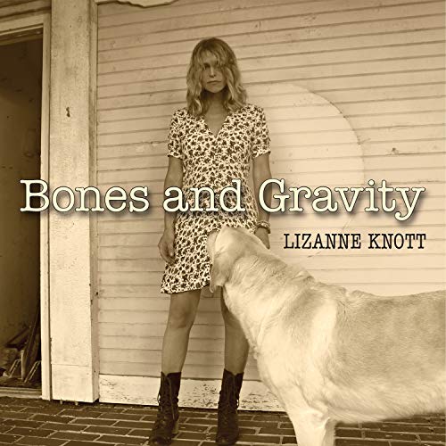 Album cover: woman in leopard dress and boots stands beside a white goat.