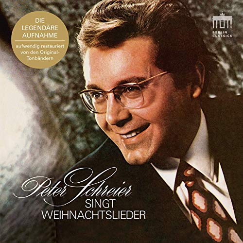 "CD cover featuring a man in a suit, smiling, with German text."