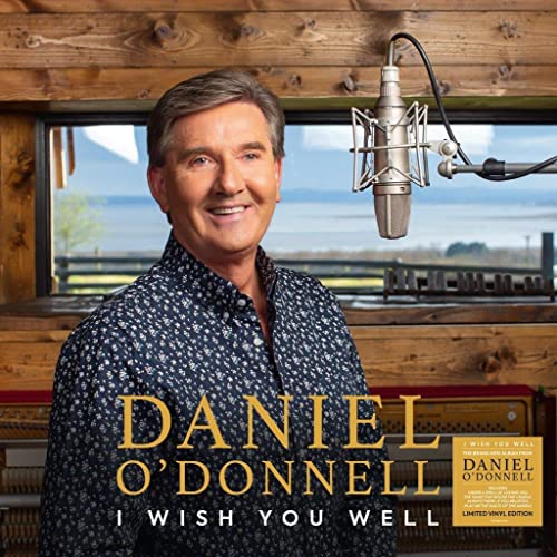Daniel O’Donnell album cover with singer, microphone, and window background.