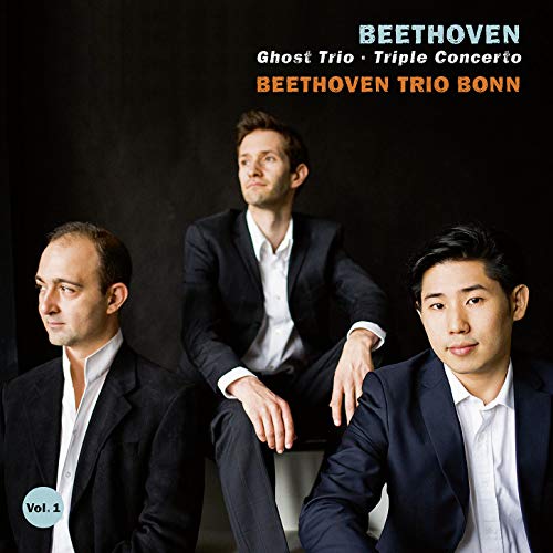 "CD cover featuring three men in black suits against a dark background."