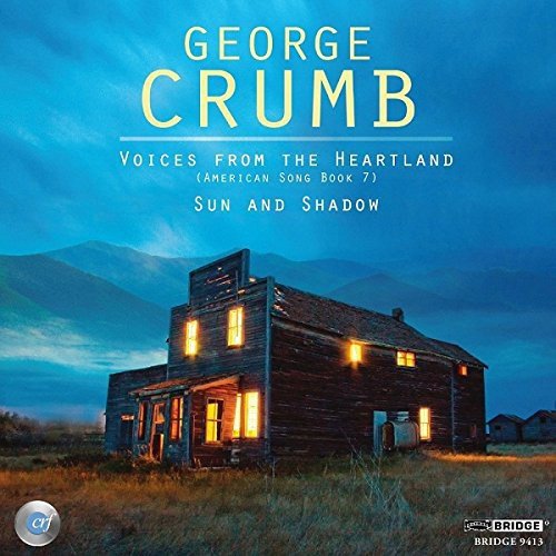"CD cover featuring a lit, old wooden house at dusk with mountains in the background."