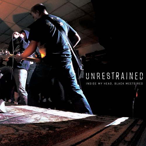 "Vinyl record cover featuring a band performing on stage with dramatic lighting."