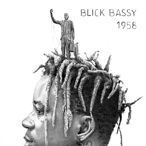 "Black and white album cover featuring a man with dreadlocks and a miniature figure on his head."