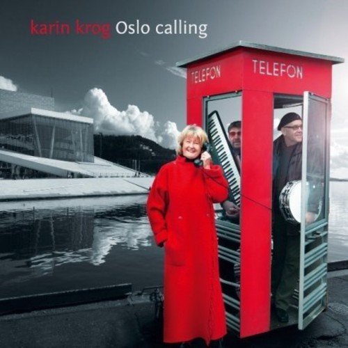 "Album cover featuring a woman in red coat using a red phone booth."