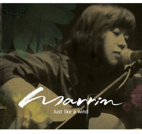 CD cover featuring a man with a guitar and floral background.