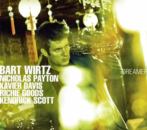 "Album cover with man holding trumpet, surrounded by hanging lights, names listed on the left."