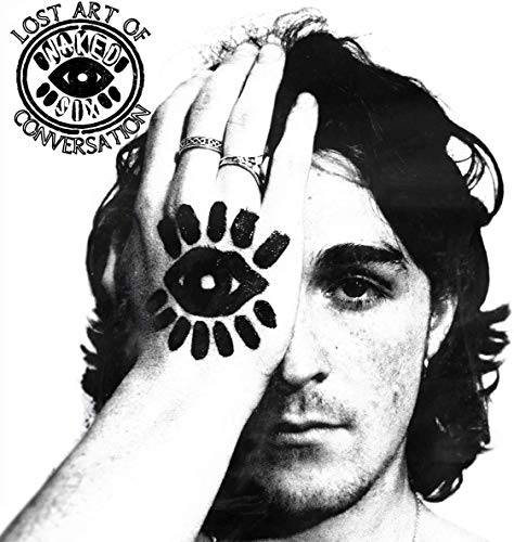 Black and white portrait of a man with an eye design on his hand.